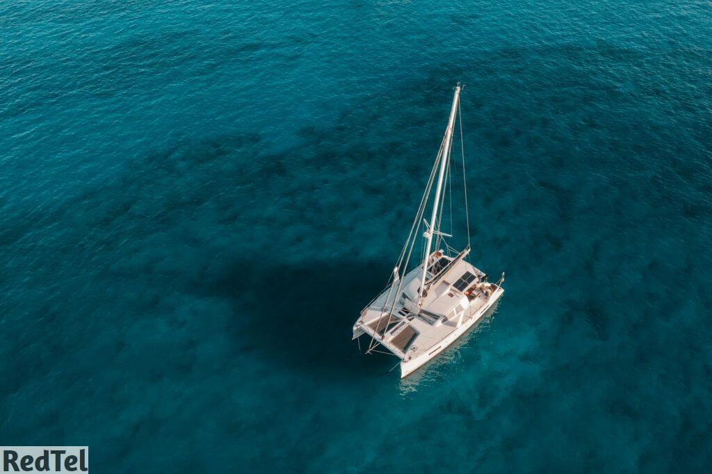 White and Blue Boat on Blue Sea