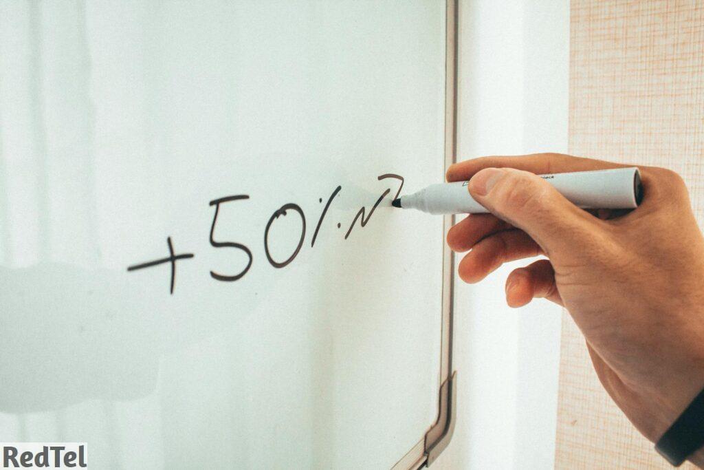 Crop male instructor writing information on whiteboard